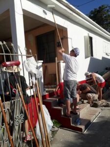 Corporate group repairing houses in St. Maarten after hurricane 